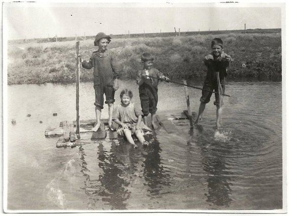 Children on a homemade raft in the 1910s.